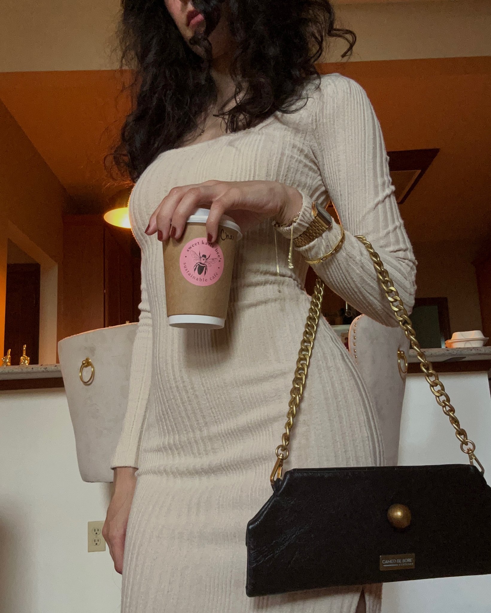 Cream ribbed dress — black de Boré chain clutch at café