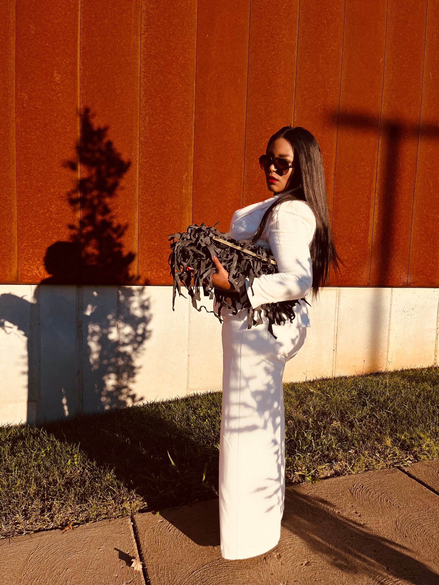 White suit with fringe clutch